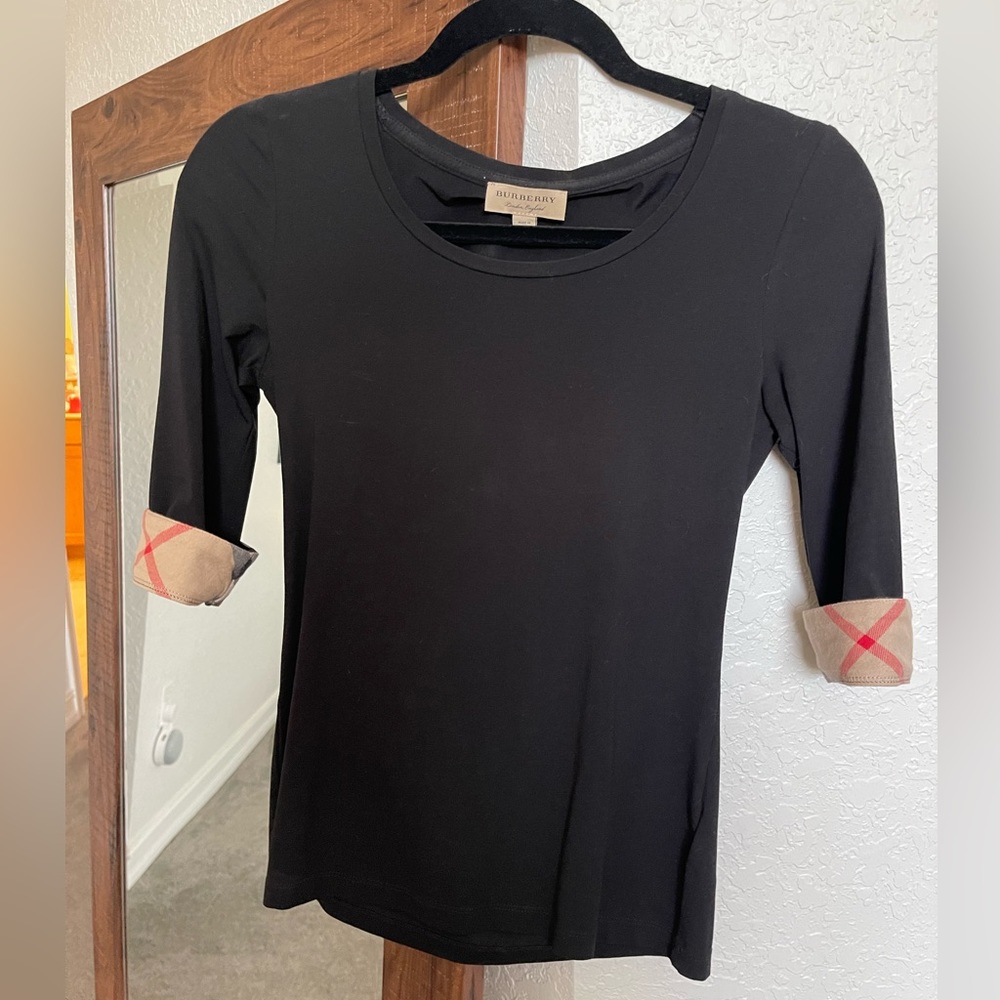 Authentic Burberry 3/4 top in black XS. Great condition.